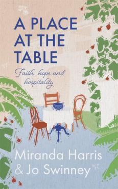 A place at the table front cover. A drawing of 3 chairs around a small table, with a blue bowl in the middle. Plant leaves around the edges of the book, to appear as if your walking along a path in a garden, and coming across the table.